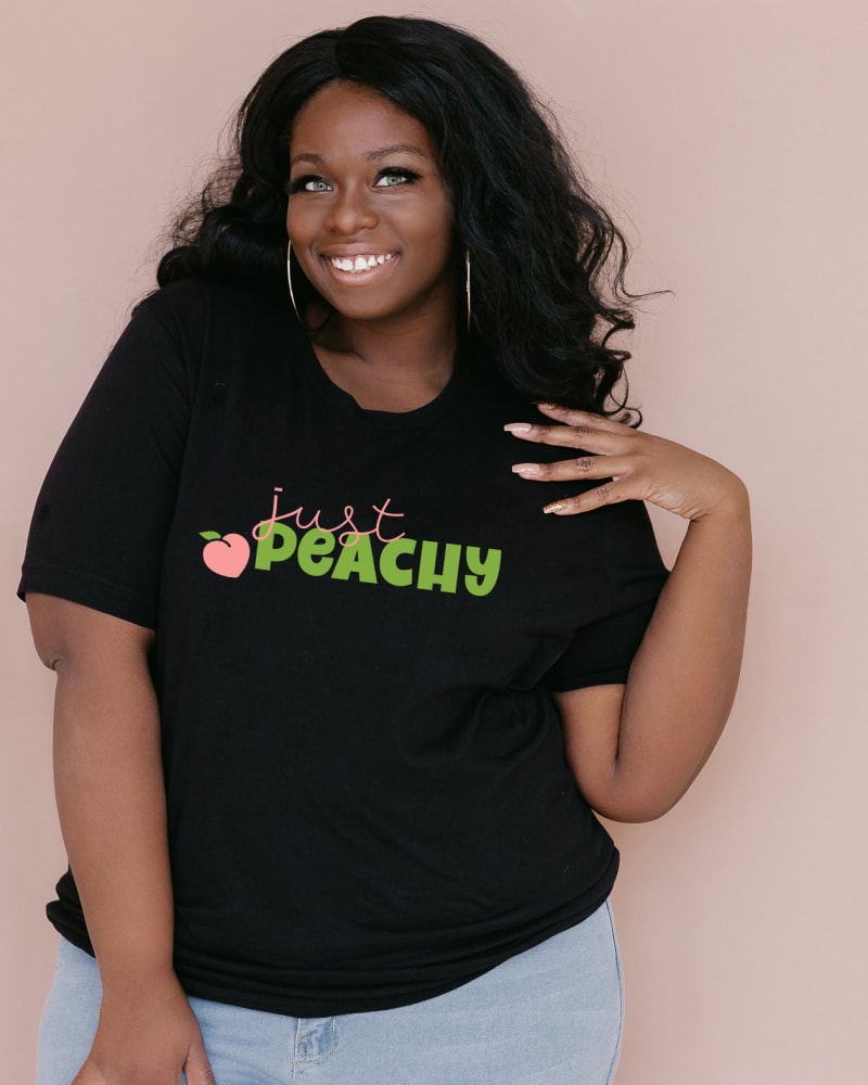 Front of a model wearing a size Large Just Peachy Green in Black by Simply Sage Market. | dia_product_style_image_id:281528